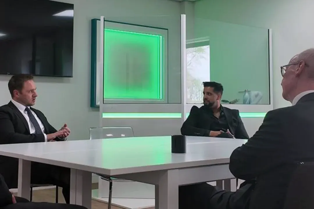Dr Lewis Haydon (left) in a business meeting