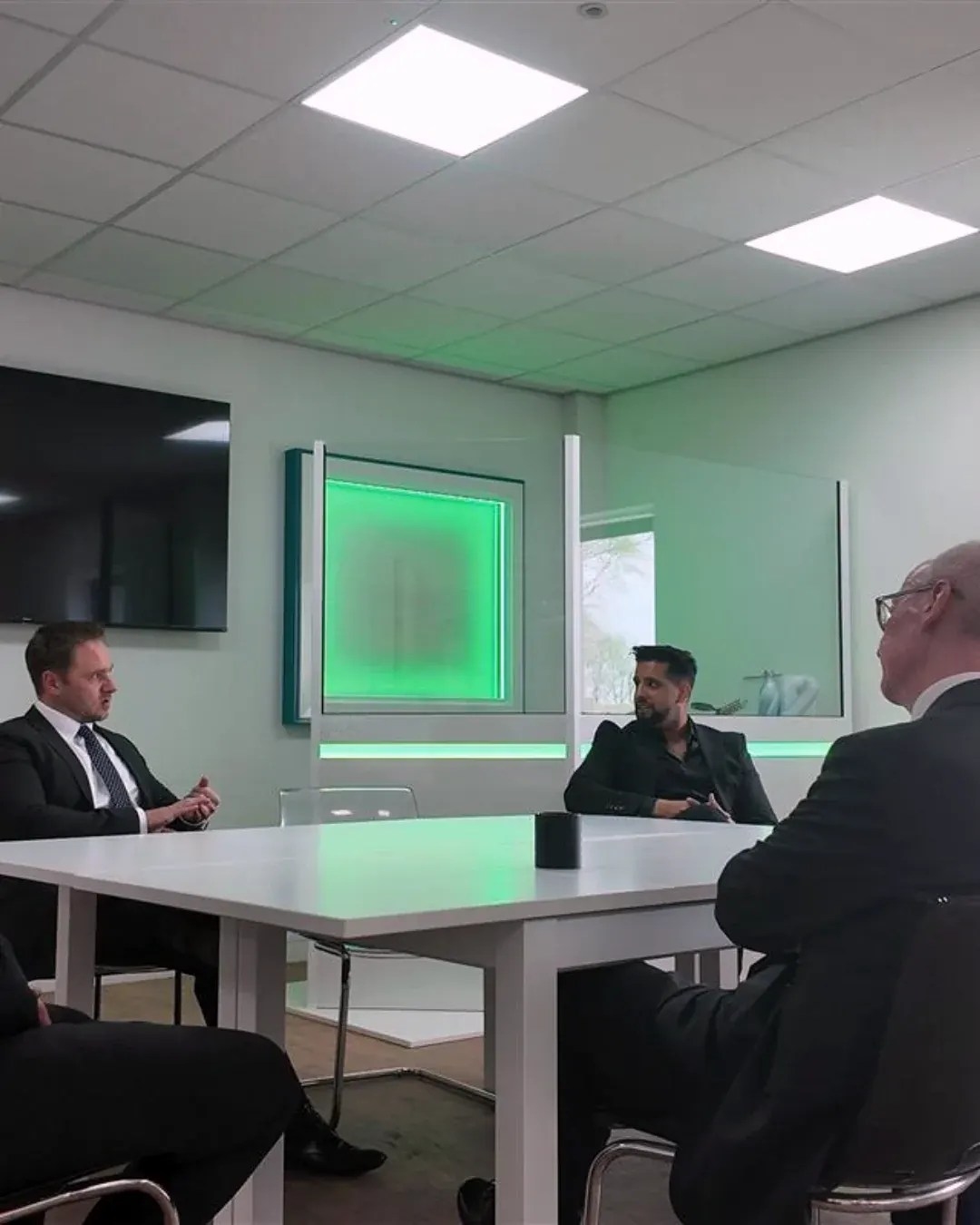 Dr Lewis Haydon (left) in a business meeting